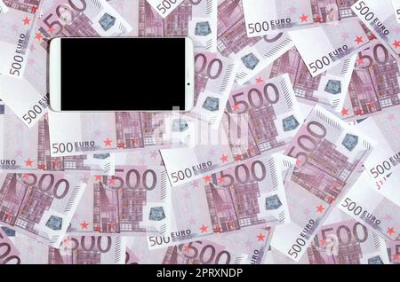 Purple 500 euro money bills and a smartphone with black screen. Copy space. The concept of online banking, money management and shopping with modern t Stock Photo