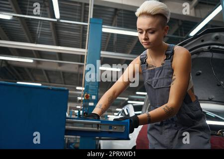 Employee at the workplace near the working box with tools Stock Photo