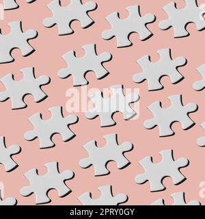 a pattern of white puzzle pieces arranged in different lines on a pale pink background Stock Photo