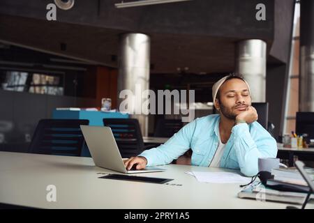 Male fell asleep on job in the office Stock Photo