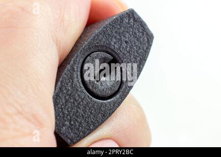 Black metal padlock with keyhole in woman hands close up on light background with copy space. Stock Photo