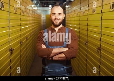 Pleased young man standing in the warehouse Stock Photo