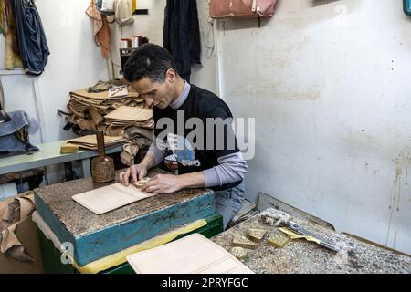 Craftsman working leather in a small workshop in the Tetouan medina. Stock Photo
