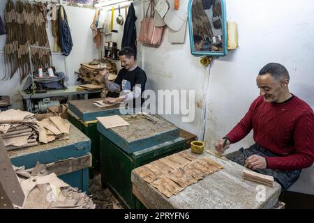 Craftsmen working leather in a small workshop in the Tetouan medina. Stock Photo