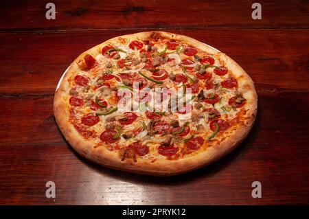 Delicious tomato sauce cheese covered hot and tasty supreme pizza pie Stock Photo