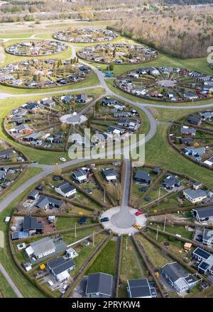 Brondby, Denmark. 27th Apr, 2023. From the air, the Danish garden city of Brondby Haveby near Copenhagen looks like the setting from a sci-fi movie. The 24 circular community gardens were laid out in the 1960s to a design by landscape architect Mygind. They resemble old Danish villages where residents met at the village well in the center to share news. (Shot with a drone). Credit: Stephan Schulz/dpa-Zentralbild/dpa/Alamy Live News Stock Photo