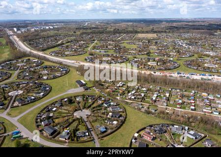 Brondby, Denmark. 27th Apr, 2023. From the air, the Danish garden city of Brondby Haveby near Copenhagen looks like the setting from a sci-fi movie. The 24 circular community gardens were laid out in the 1960s to a design by landscape architect Mygind. They resemble old Danish villages where residents met at the village well in the center to share news. (Shot with a drone). Credit: Stephan Schulz/dpa-Zentralbild/dpa/Alamy Live News Stock Photo