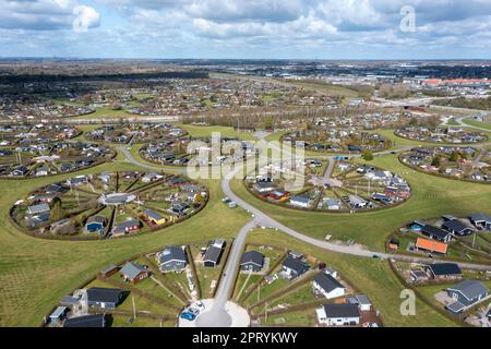 Brondby, Denmark. 27th Apr, 2023. From the air, the Danish garden city of Brondby Haveby near Copenhagen looks like the setting from a sci-fi movie. The 24 circular community gardens were laid out in the 1960s to a design by landscape architect Mygind. They resemble old Danish villages where residents met at the village well in the center to share news. (Shot with a drone). Credit: Stephan Schulz/dpa-Zentralbild/dpa/Alamy Live News Stock Photo