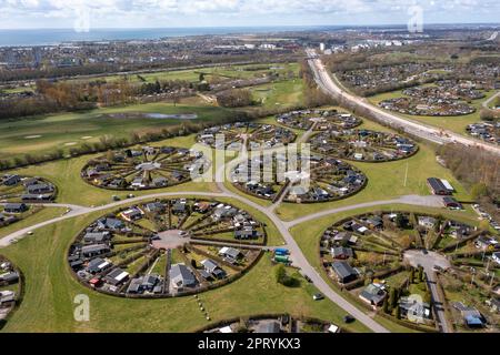 Brondby, Denmark. 27th Apr, 2023. From the air, the Danish garden city of Brondby Haveby near Copenhagen looks like the setting from a sci-fi movie. The 24 circular community gardens were laid out in the 1960s to a design by landscape architect Mygind. They resemble old Danish villages where residents met at the village well in the center to share news. (Shot with a drone). Credit: Stephan Schulz/dpa-Zentralbild/dpa/Alamy Live News Stock Photo