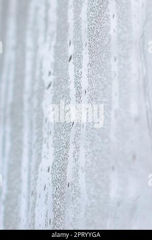 The texture of a misted glass with a lot of drops and condensation ...