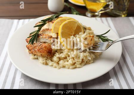 Delicious chicken risotto with lemon on table, closeup Stock Photo