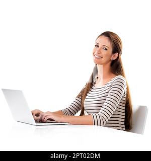 Shes a hardworker. Studio portrait of a young woman using a laptop against a white background Stock Photo