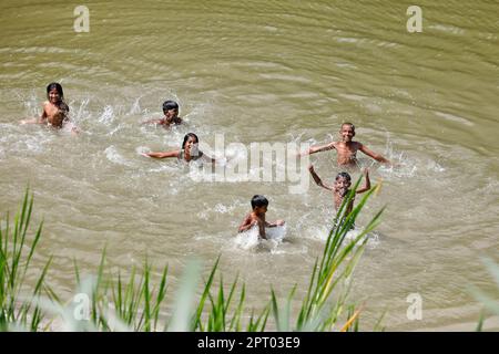 Shariatpur, Bangladesh - April 23, 2023: For the past few days, there has been intense heat wave in Bangladesh. In Shariatpur, the child is playing in Stock Photo
