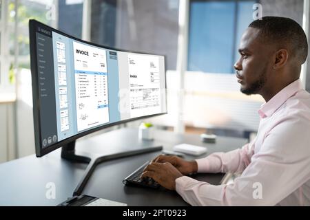 E Invoice Business Management. African Accountant Using Electronic Invoice Stock Photo