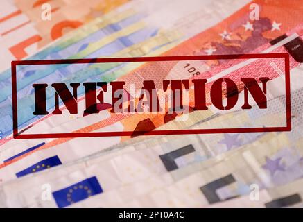 A stamp with the red lettering Inflation on numerous euro banknotes - Financial crisis concept in Germany and Europe Stock Photo