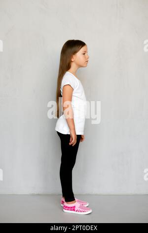 Beautiful little blonde long haired child girl in white tights