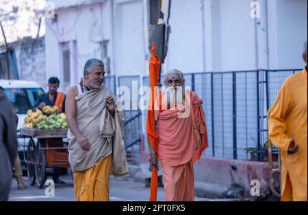 Portrait of Unidentified Indian sadhu baba walking on ghat near river ganges in varanasi city in traditional dress. Varanasi is oldest and holy city. Stock Photo