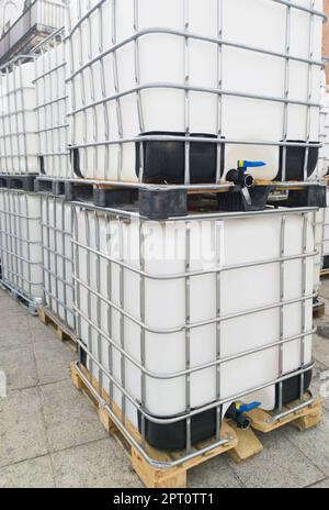 Lots of cube water tanks. 1000 litres containers piled outdoors Stock Photo