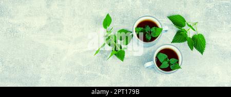 Teacup with herbal tea, healing tea with fresh nettle. Homeopathy, herbal medicine. Stock Photo