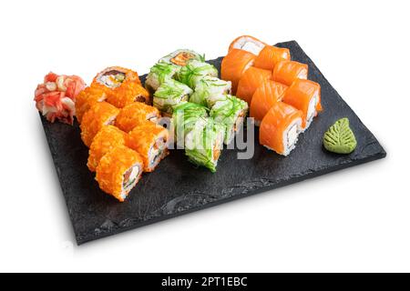 Big set of rolls with wasabi and pickled ginger on stone serving board isolated on white Stock Photo
