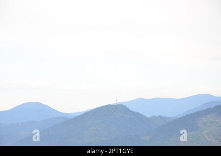 Fragment of the mountainous terrain in the Carpathians, Ukraine. The forest is forgiven by the reliefs of the Carpathian Mountains Stock Photo