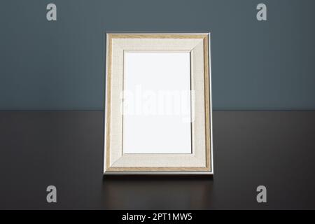 Photo frame picture Mockup on table with dark blue wall Stock Photo