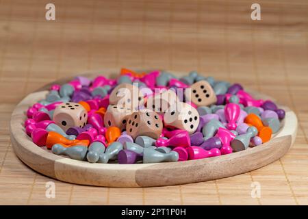 Many colorful game pieces and dice for board games Stock Photo