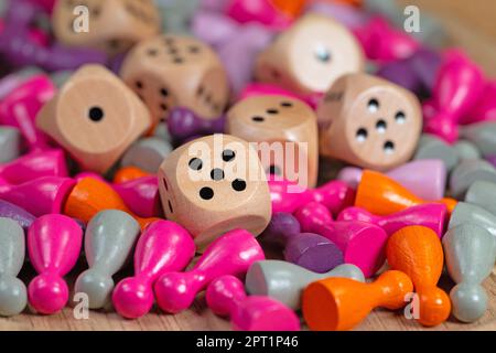 Many colorful game pieces and dice for board games Stock Photo