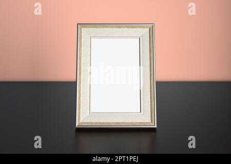 Photo frame picture Mockup on table with light orange wall Stock Photo