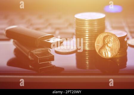 USB flash cards lying on black laptop case in front of his keyboard. The concept of earning on the Internet, online monetization and payment of virtua Stock Photo