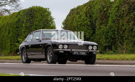 Bicester,Oxon,UK - April 23rd 2023. 1971 JENSEN INTERCEPTOR car travelling on an English country road Stock Photo