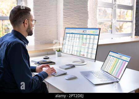 Auditor Employee And Data Analyst Using Computer Spreadsheet Stock Photo