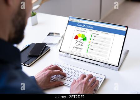 Online Credit Score Check Using Laptop Computer Stock Photo