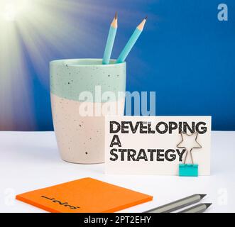 Handwriting text Developing A Strategy, Word Written on Discussing the Ideas for New Goal Marketing Vision Planning Business Stock Photo