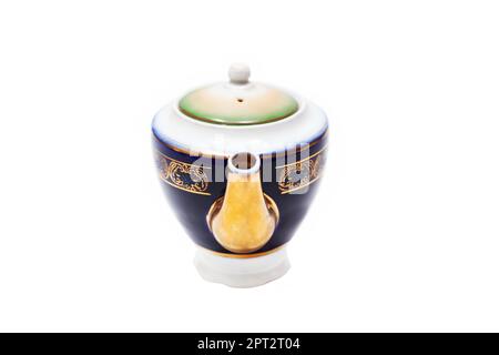 Old-fashioned beautiful gilded porcelain teapot on a white background Stock Photo