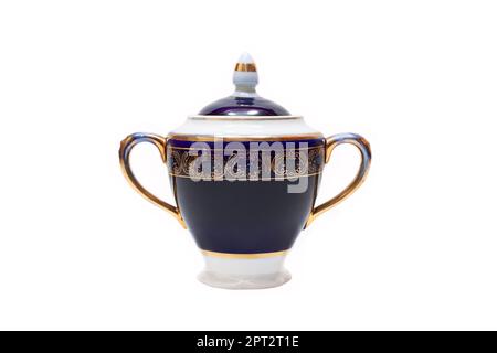 Old-fashioned beautiful gilded porcelain sugar bowl on a white background Stock Photo