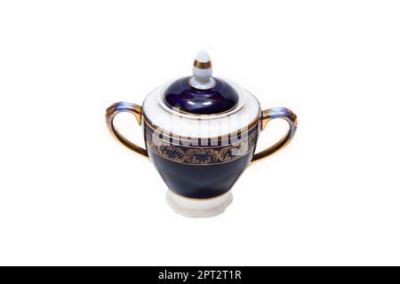 Old-fashioned beautiful gilded porcelain sugar bowl on a white background Stock Photo