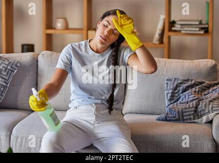Spring cleaning, tired and sad woman headache in home living room with burnout, stress and frustrated spray task. Fatigue, pain and depression, housek Stock Photo