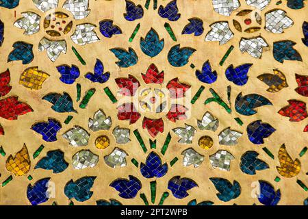 Multi-colored glass decorated on the wall of the temple in Thailand. Stock Photo