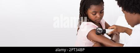 African American Dermatology Consultation. Doctor Checking Child Skin Stock Photo