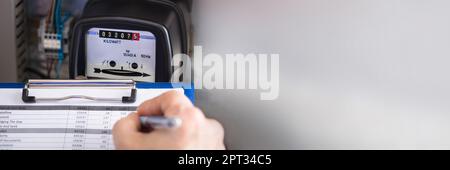 Electricity Counter Metering System. Engineer Reading Meter Stock Photo