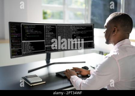 African American Man Programmer. Coding On Computer Stock Photo