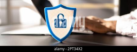 African American Man Using Secure Computer. Shield Sign Stock Photo