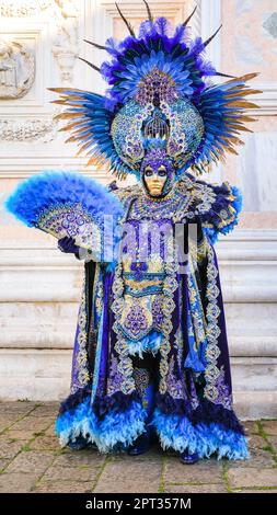 Venice Carnivale, two participants in turquoise blue Venetian baroque peacock inspired costume with feathers, mask and hat, Venezia, Italy Credit: Imageplotter/Alamy Live News Stock Photo