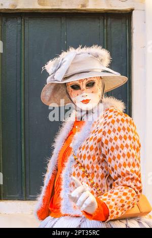 Venice Carnival, costumed female participant in colourful fancy dress, hat and mask poses, Venice Italy, Credit: Imageplotter/Alamy Live News Stock Photo