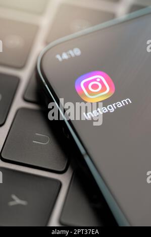New york, USA - April 25, 2023: Open instagram app on smartphone screen close up view keyboard background Stock Photo
