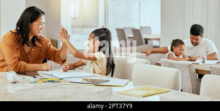 High five, homework and parents with support for children, motivation and goal in education in their house. Happy, excited and girl learning, studying Stock Photo