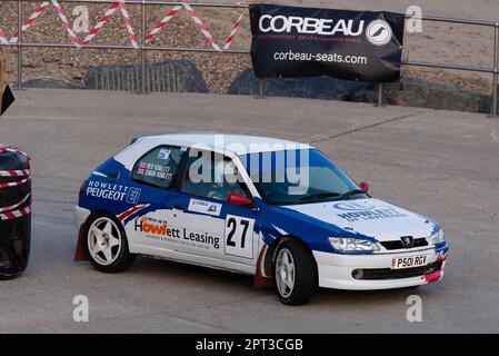 Ben Howlett racing a Peugeot 306 competing in the Corbeau Seats rally on the seafront at Clacton on Sea, Essex, UK. Co driver Simon Howlett Stock Photo