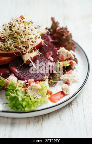 Beet and Apple Salad on mixed Greens with Strawberry Vinaigrette Stock Photo