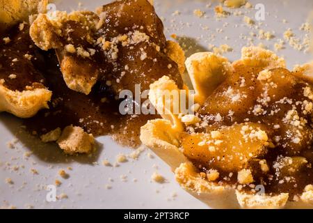 100mm Macro of Apple Tartlets, small tarts, small pie, crumbs, shortbread crust and broken in pieces. Stock Photo